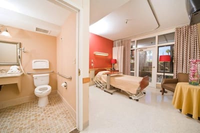 Private resident room with a bathroom and patio view