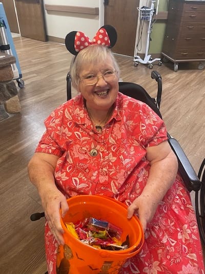 Resident enjoying a festive activity with candy