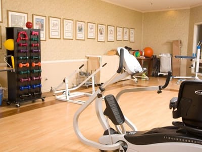 Interior of a fitness room with exercise equipment and weights