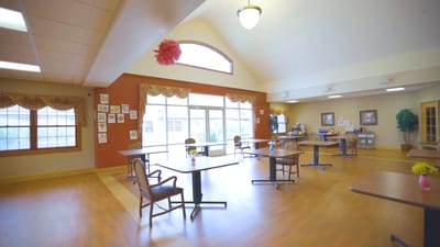 Bright common area with tables and chairs set up