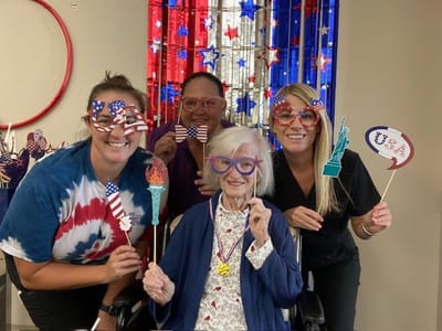 Residents and staff celebrating with patriotic props