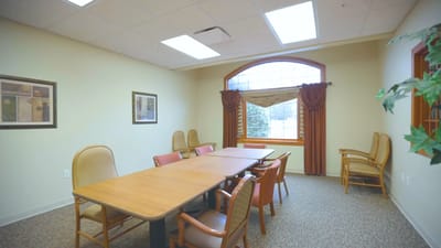 Interior view of a meeting room with a large table and chairs
