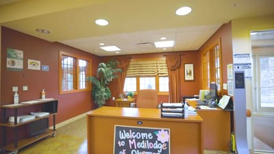 Reception area of Medilodge of Okemos showing desk and decor