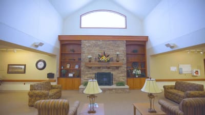 Bright common area with comfortable seating and a fireplace
