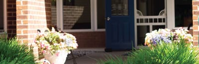 Entrance with blue door and flower pots