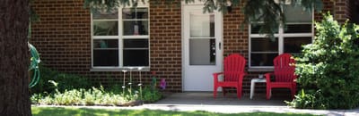 Outdoor space with red chairs and greenery