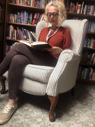 Woman reading a book in a cozy chair