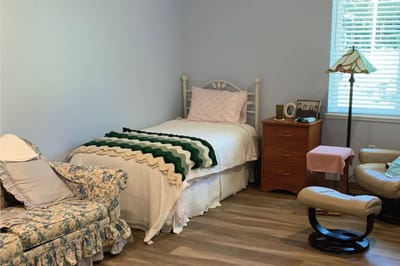 Cozy bedroom with a bed and chair