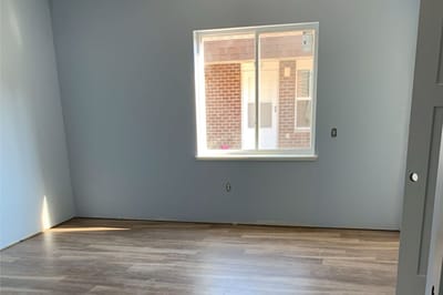 Empty room with a window and hardwood floor