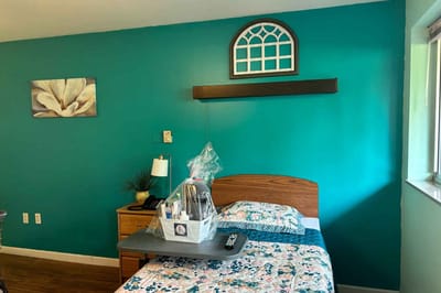 Brightly colored resident room with personal touches.