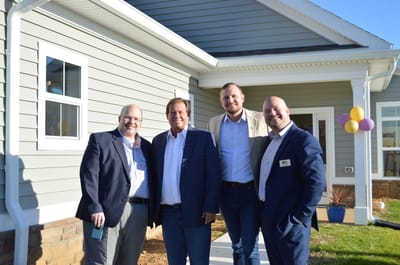 Four men standing in front of a nursing home