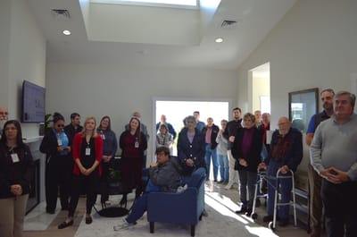 Residents and staff gathered in a common room