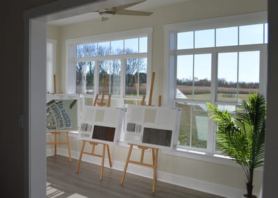 Sunlit room with easels and nature views