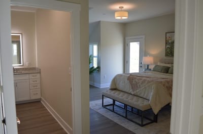 Bright, welcoming resident room with a bed and bath