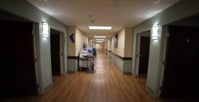 A hallway in a nursing home facility with medical equipment
