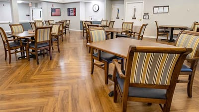 Dining area with wooden tables and striped chairs