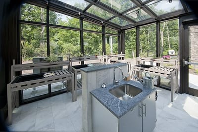 Indoor garden area with minimal seating and view of greenery