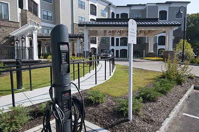 Exterior view of Allegro Harrington Park with charging station