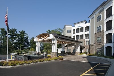 Exterior view of Allegro Harrington Park with American flag