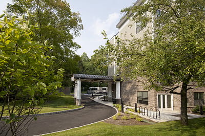 Entrance of Allegro Harrington Park with pathway and greenery