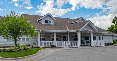 Exterior view of Amelia Senior Living with landscaped entrance