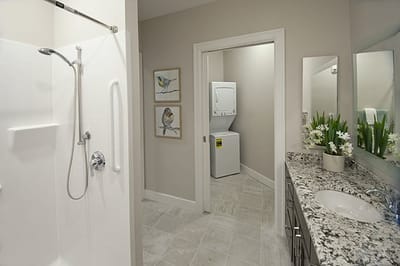 Interior view of a well-designed bathroom with laundry