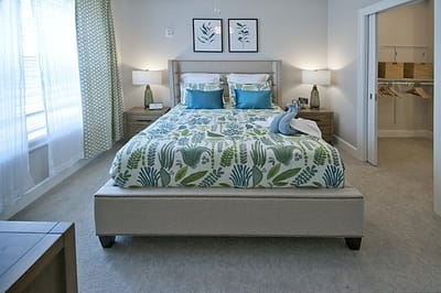 Bright and welcoming resident bedroom with floral decor