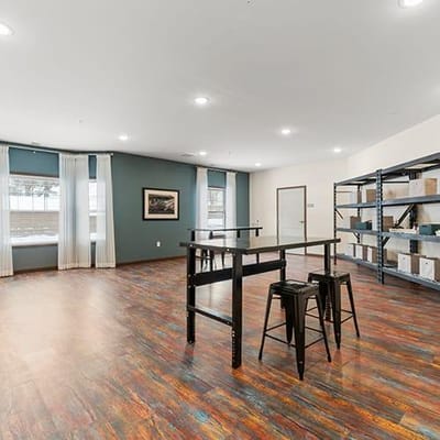 Interior view of a community room with stools and shelves