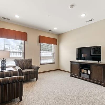 Cozy resident room with seating area and TV