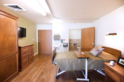 Bright interior of a private resident room with wood furnishings