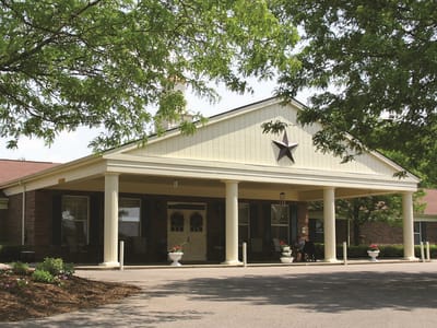 Altercare Majora Lane, Nursing Home in Millersburg, OH — Senior living facility entrance with trees and decorative star