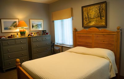 Cozy resident room with a bed and dresser
