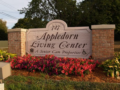 Exterior sign for Appledorn Living Center with flowers