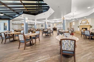 Bright, spacious dining room with tables set for meals