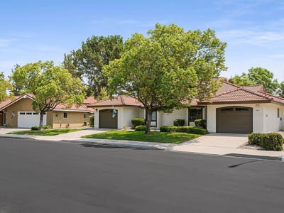 Exterior view of a senior living community with homes and trees