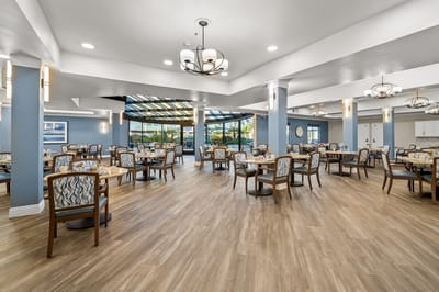 Bright dining room with tables set for residents