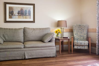 Cozy lounge area with a couch and lamp