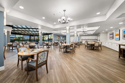 Dining room with tables and chairs set for meals