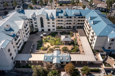 Aerial view of a senior living facility with gardens and outdoor space