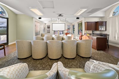 Interior view of a common area with seating and a projector