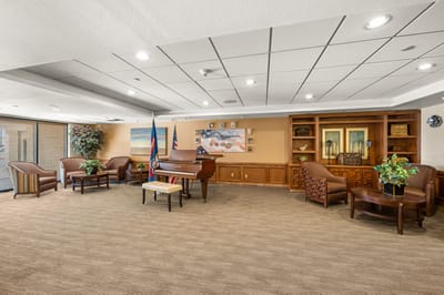 Interior view of a common area with seating and a piano