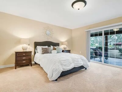 Brightly decorated private resident room with a bed and patio access