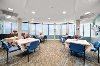 Bright activity room with tables and flowers