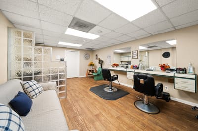 Hair salon area with styling chairs and mirrors
