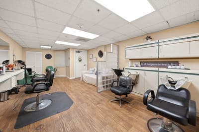 Hair salon area with styling chairs and mirrors