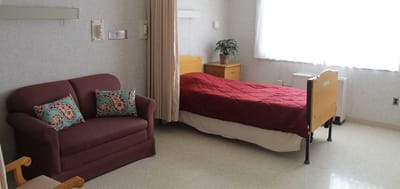 Interior view of a resident's room with a sofa and bed