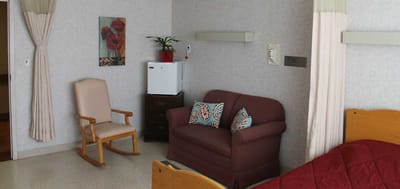Cozy resident room with a couch and rocking chair