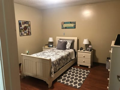 Cozy interior view of a resident's room with bed and decorations