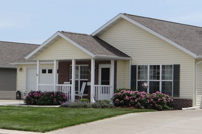 Exterior view of a cottage-style residence with flowers