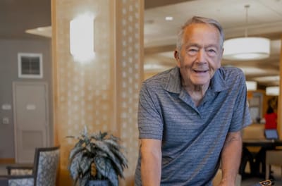 Senior man smiling in a common area